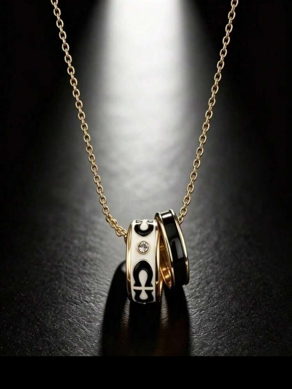 Gold Tone Necklace with Black and White Ring Pendants